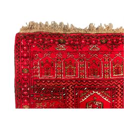 Afghan red ground prayer rug, the field decorated with stepped flat arch and Gul motifs (119cm x 80cm); together with a similar Afghan red ground prayer rug, with three pointed arches decorated with Gul motifs (108cm x 79cm)