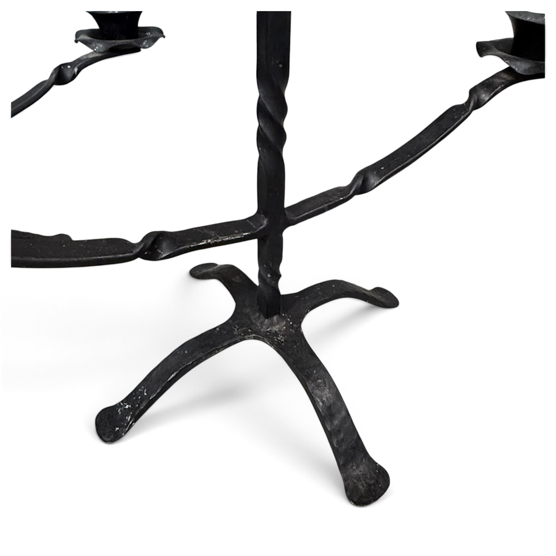 Collection of wrought iron candle stands, comprising five-light and three-light floor-standing candelabra with scrolling branches, and a pair of five-light table candelabra of naturalistic branching form
