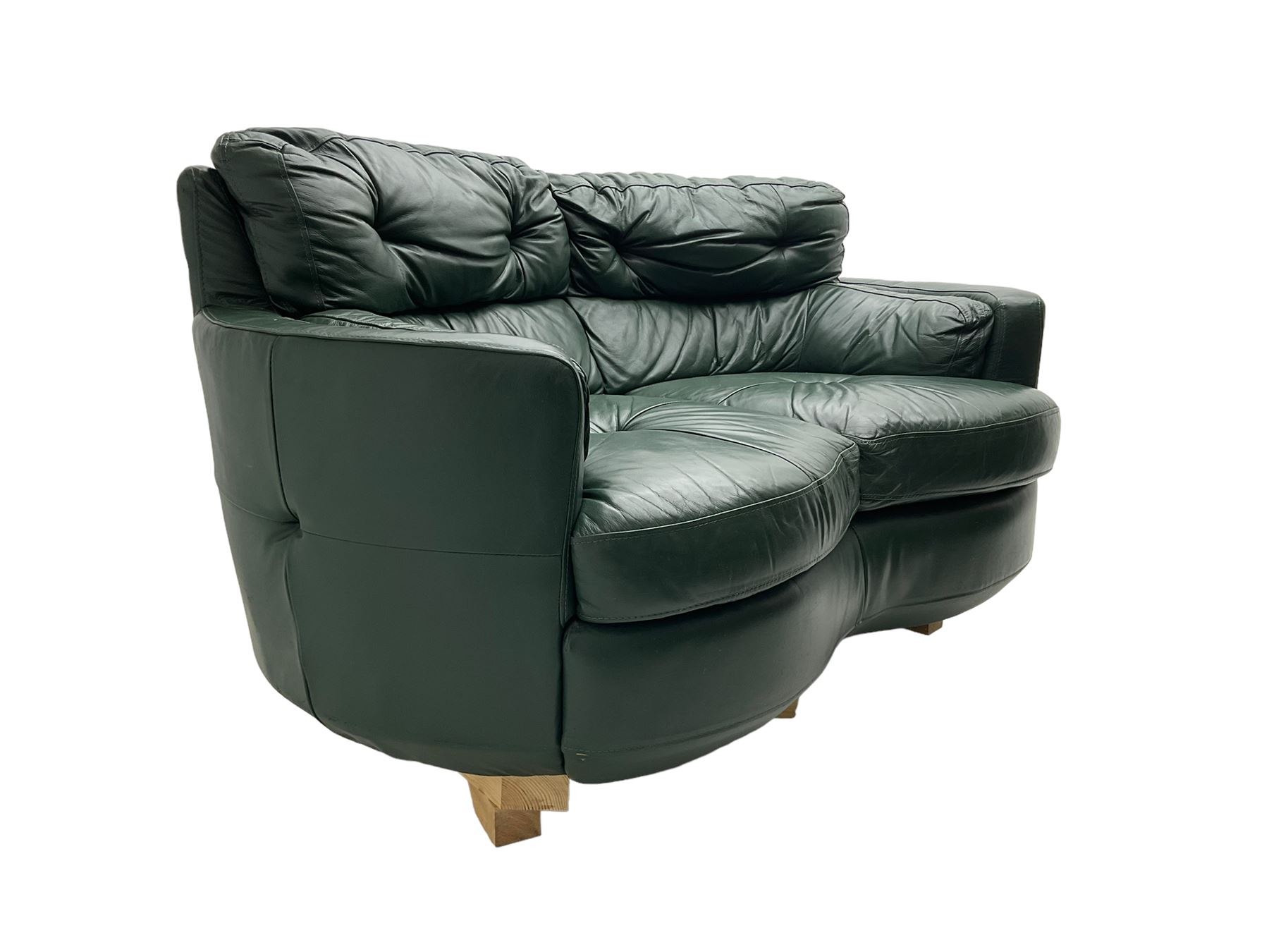 Two seat serpentine sofa, upholstered in green buttoned leather