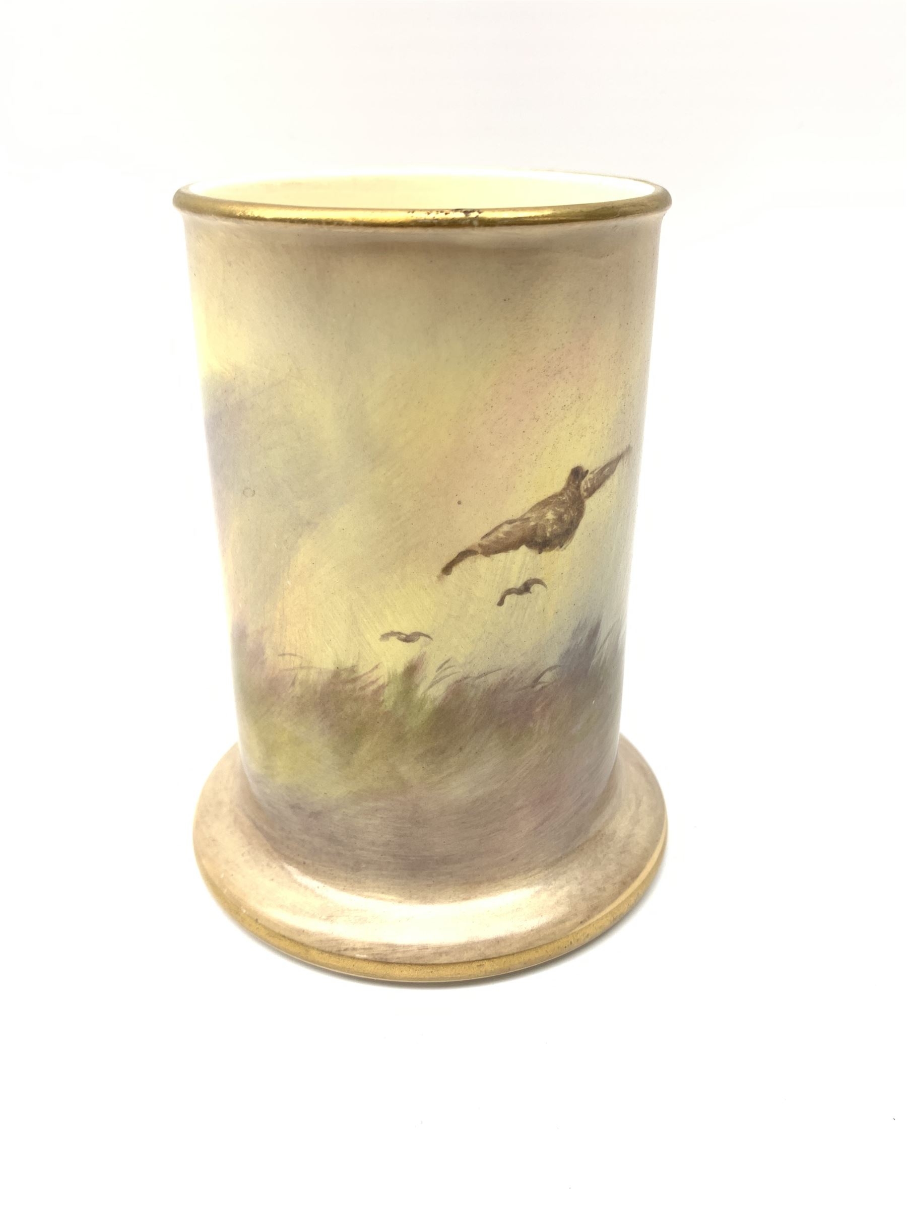 A Crown Devon Fieldings vase, of cylindrical form painted with a highland cattle scene and signed Cox, with printed marks beneath, H11.5cm