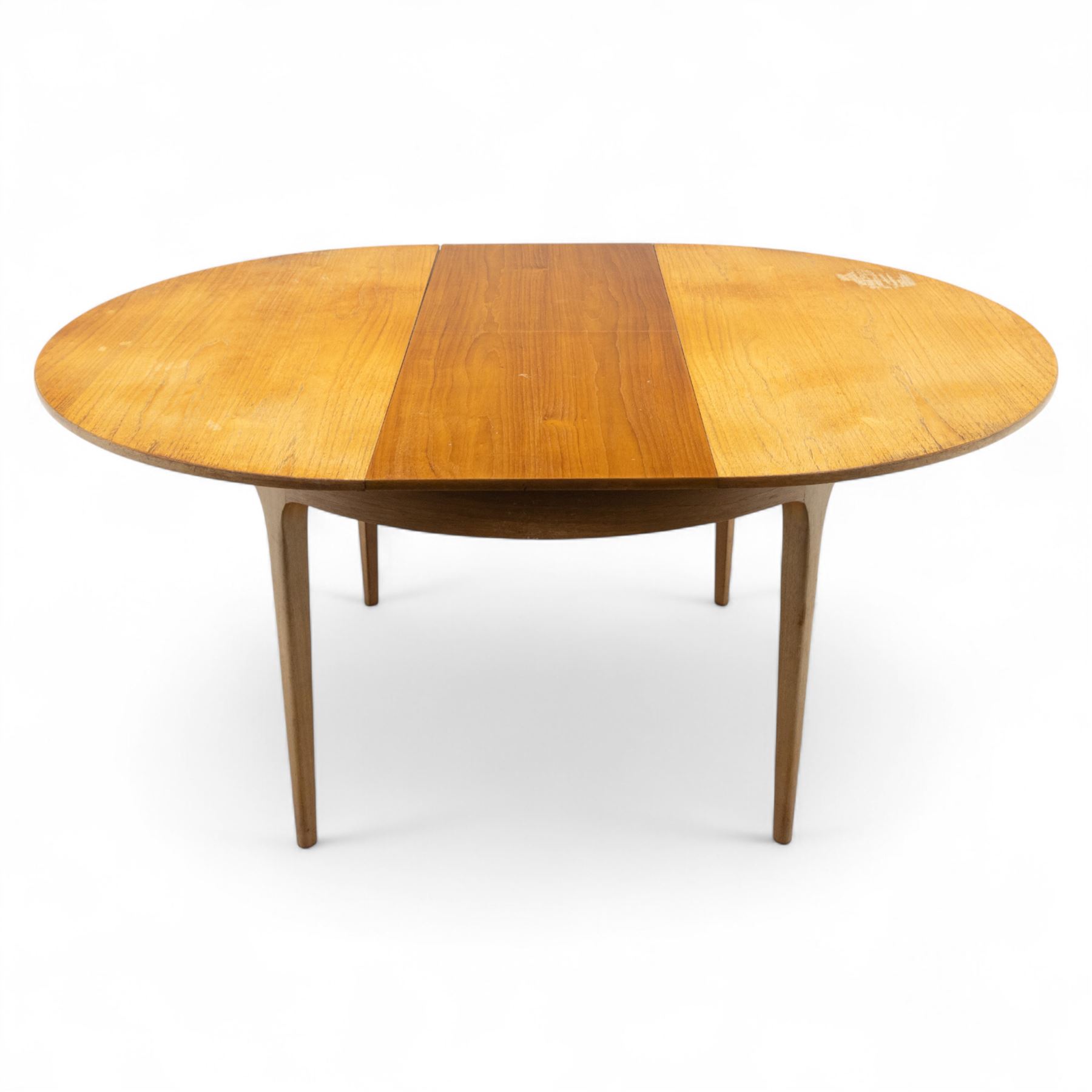 Sutcliffe of Todmorden - mid 20th century ‘S-Form’ teak dining table and chairs, the circular storable extending table with plain veneered top on tapered supports, together with matching dining chairs upholstered in black vinyl, with curved slat backs and shaped front supports, reflecting the sleek organic styling characteristic of 1960s British modern furniture design (Chairs H 93cm, W 46cm, D 46cm) (Extended 168cm)