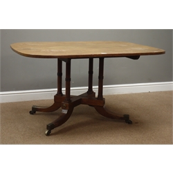  Regency style mahogany breakfast table, rectangular tilt top on four ring turned columns and sabre legs with brass castors, W127cm, D92cm, H68cm  