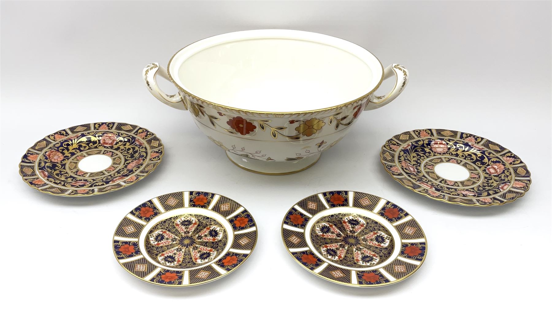 A pair of early 19th century Spode Imari 1823 pattern plates, D19cm, together with two Royal Crown derby Imari 1128 pattern plates, D16cm, and a Crown Derby A962 pattern twin handled open tureen, not including handles D28.5cm. (5). 