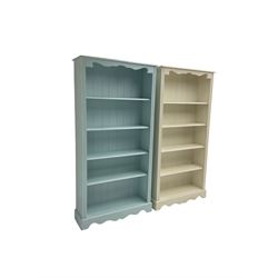 Pair painted pine open bookcases, shaped frieze over four shelves with reeded uprights, painted pale teal and cream  (2) 
