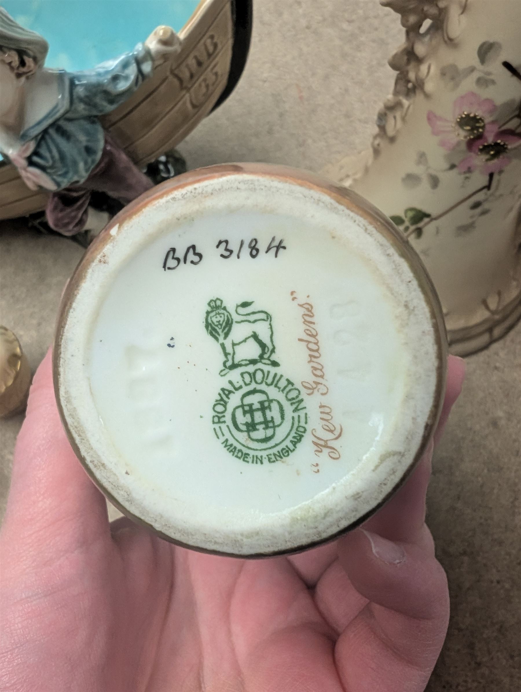 Royal Doulton Kew Gardens vase, signed J Price, together with a Royal Worcester blush ivory three piece cruet set, a Ernst Wahliss ewer, etc 