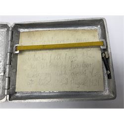 Aluminium cigarette case, by repute made from the R.38. Airship wrecked over Hull August 24th 1921, together with a aluminium matchbox cover, the front inscribed 'R38 WRECKED AT HULL 24 AUG 1921 44 LIVES LOST', the event illustrated verso, (2)