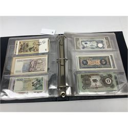 World banknotes, including Queen Elizabeth II The States of Jersey one pound 'DB202703', five pounds 'BB527762' and ten pounds 'AB651481', reserve bank of New Zealand two dollars '1L3 741894', King George V Straits Settlements one dollar 1st January 1935 'F/83 28924', various Bank of England notes etc, housed in two ring binder albums