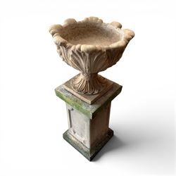 Cast stone five sectional urn on plinth, squat leaf and petal design urn on square base