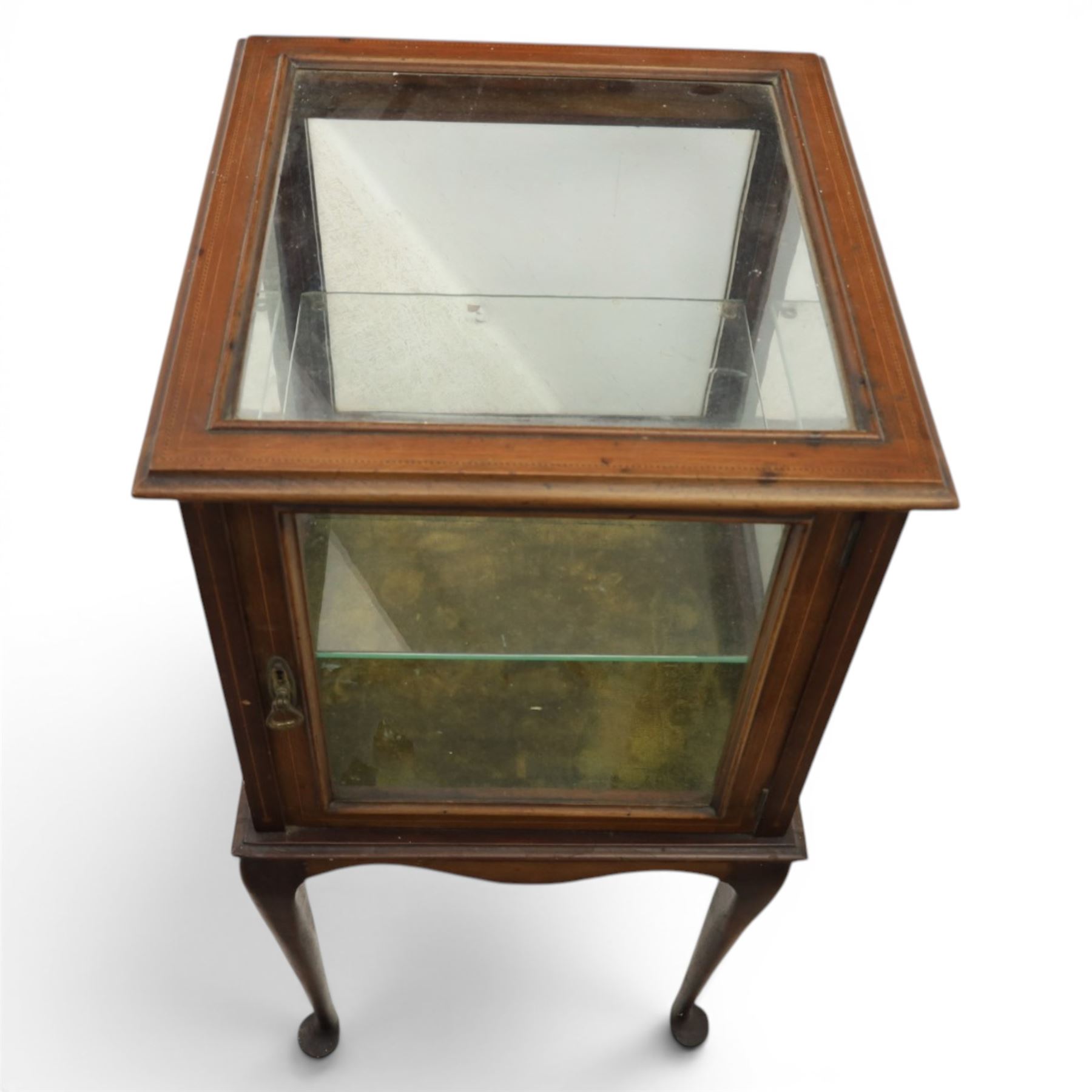 Edwardian bijouterie two tier table, glazed top and sides with inlay surround, glazed door enclosing a single shelf and baized lined interior, raised on cabriole supports