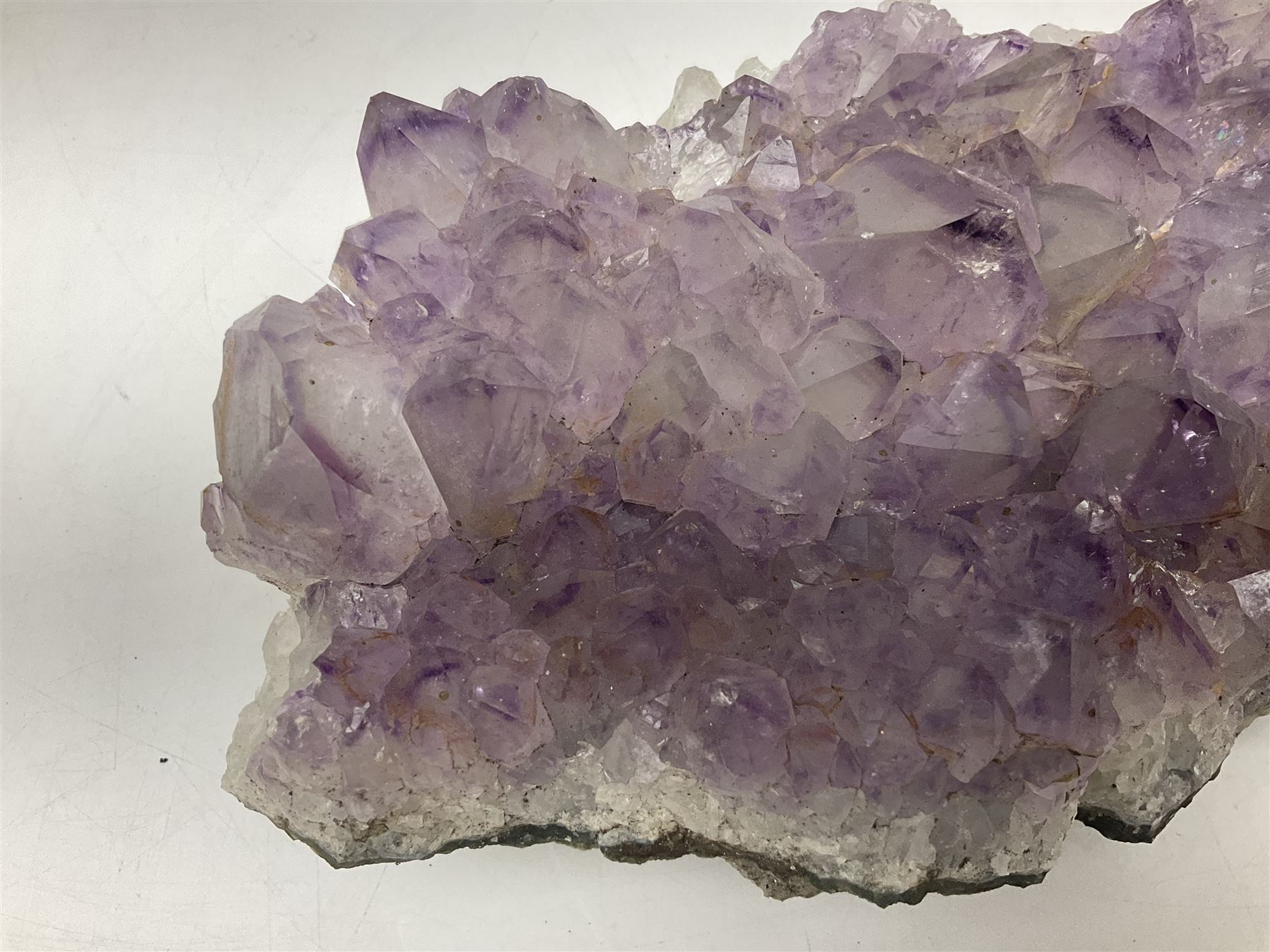 Amethyst crystal geode cluster, with well-defined crystals of various sizes, H10cm, L30cm