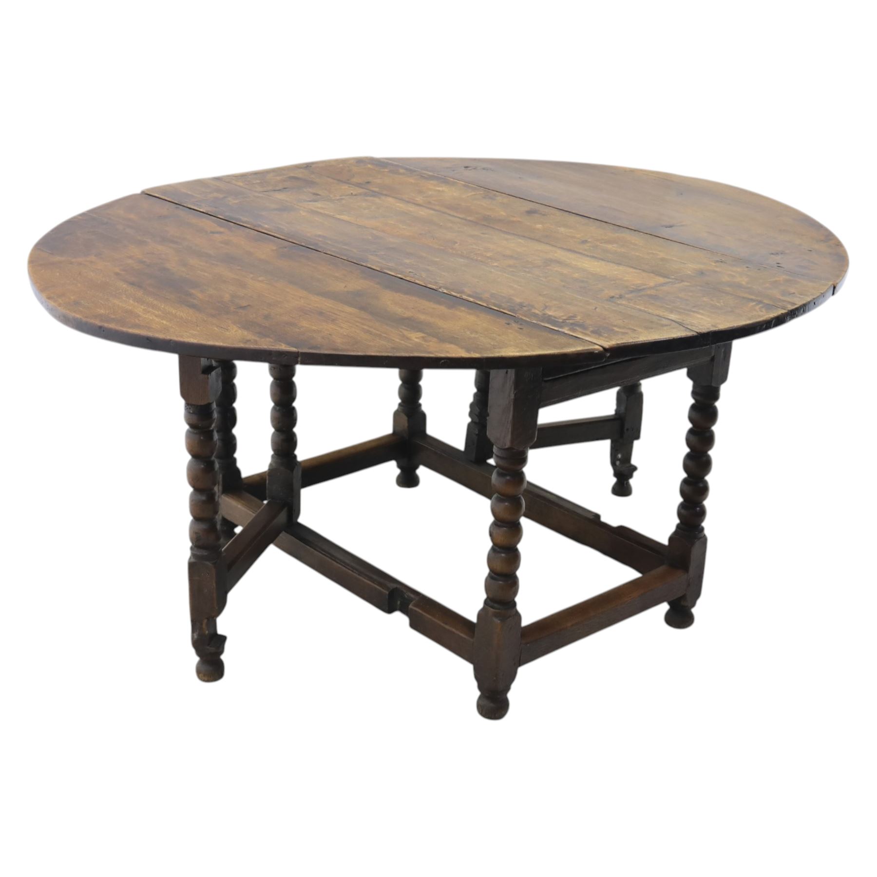 18th century country oak oval dining table, plank top with two drop leaves and gate-leg action, single drawer, raised on bobbin turned legs