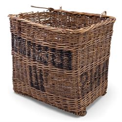 Large 20th century wicker laundry basket, of rectangular form, with stencilled lettering to one sides, raised on wooden base skids