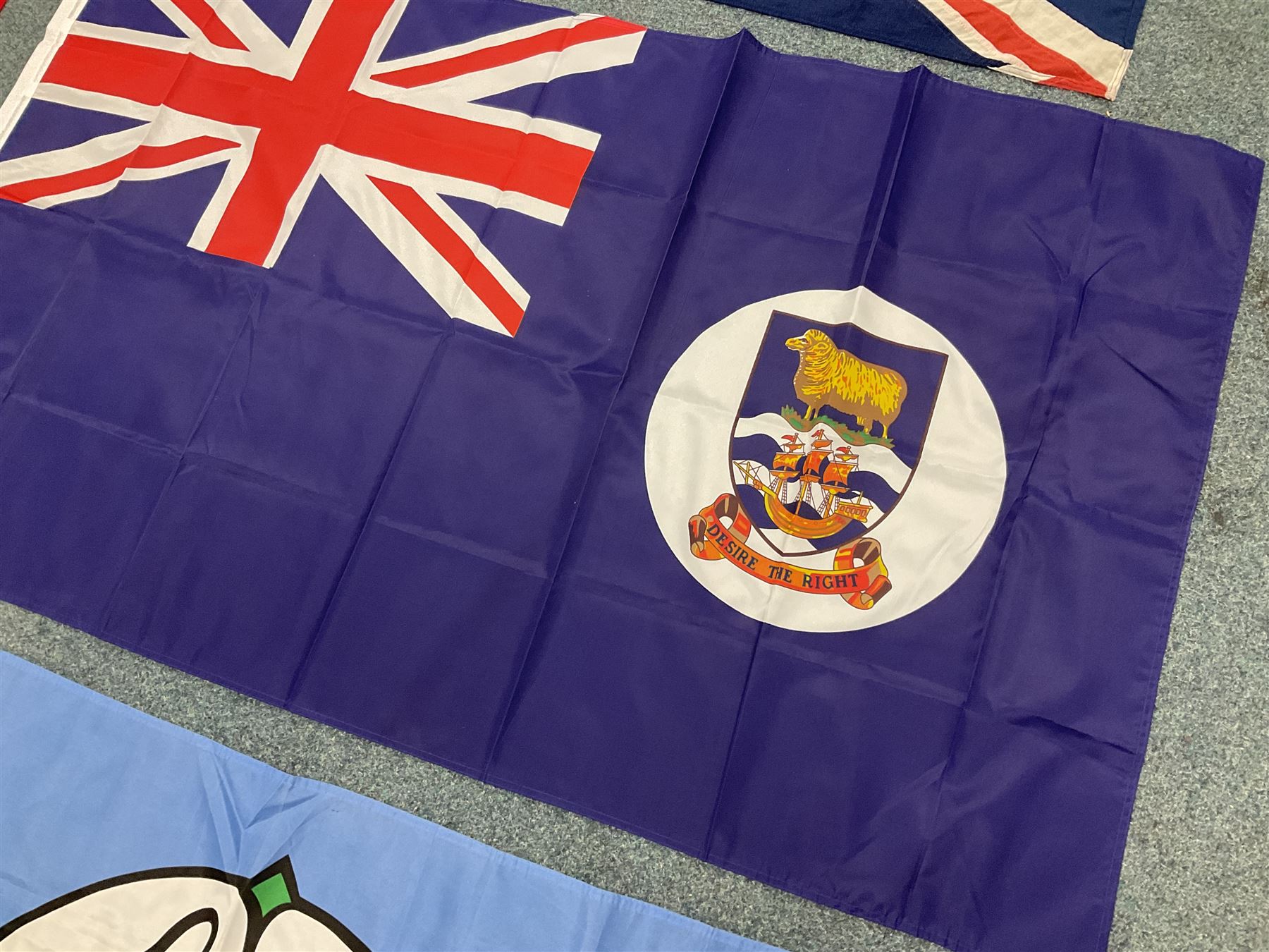 Six flags - White Ensign 180 x 86cm; two Union flags 180 x 86cm and 132 x 62cm; Falklands Islands 153 x 89cm; Yorkshire Rose 153 x 89cm; and QEII 1953 Coronation 84 x 57cm (6)