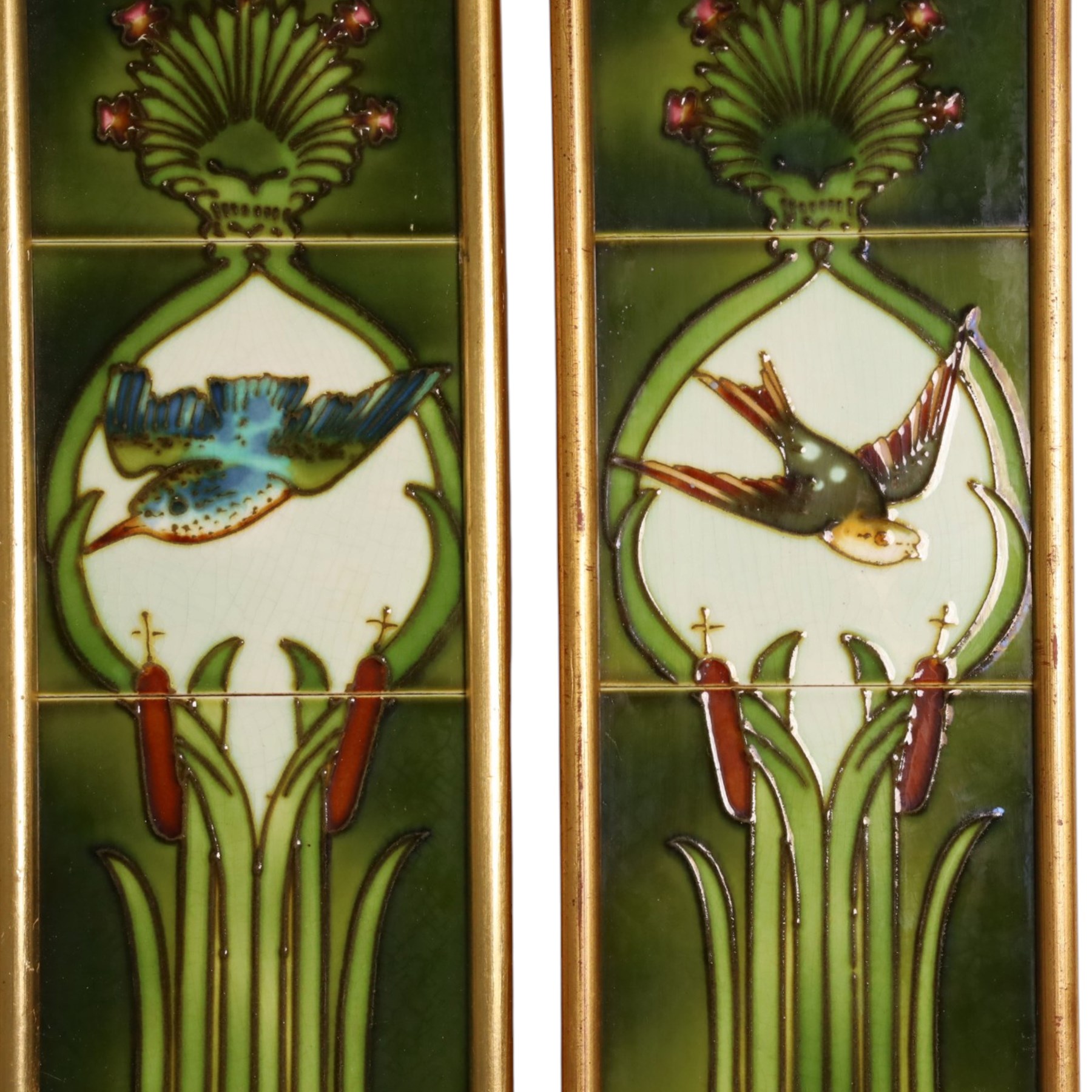 Pair of framed Art Nouveau fireside tile sets, each with five tube-lined tiles one depicting a kingfish, the other a swallow, above bulrushes, with a white lily pond beneath, H79cm