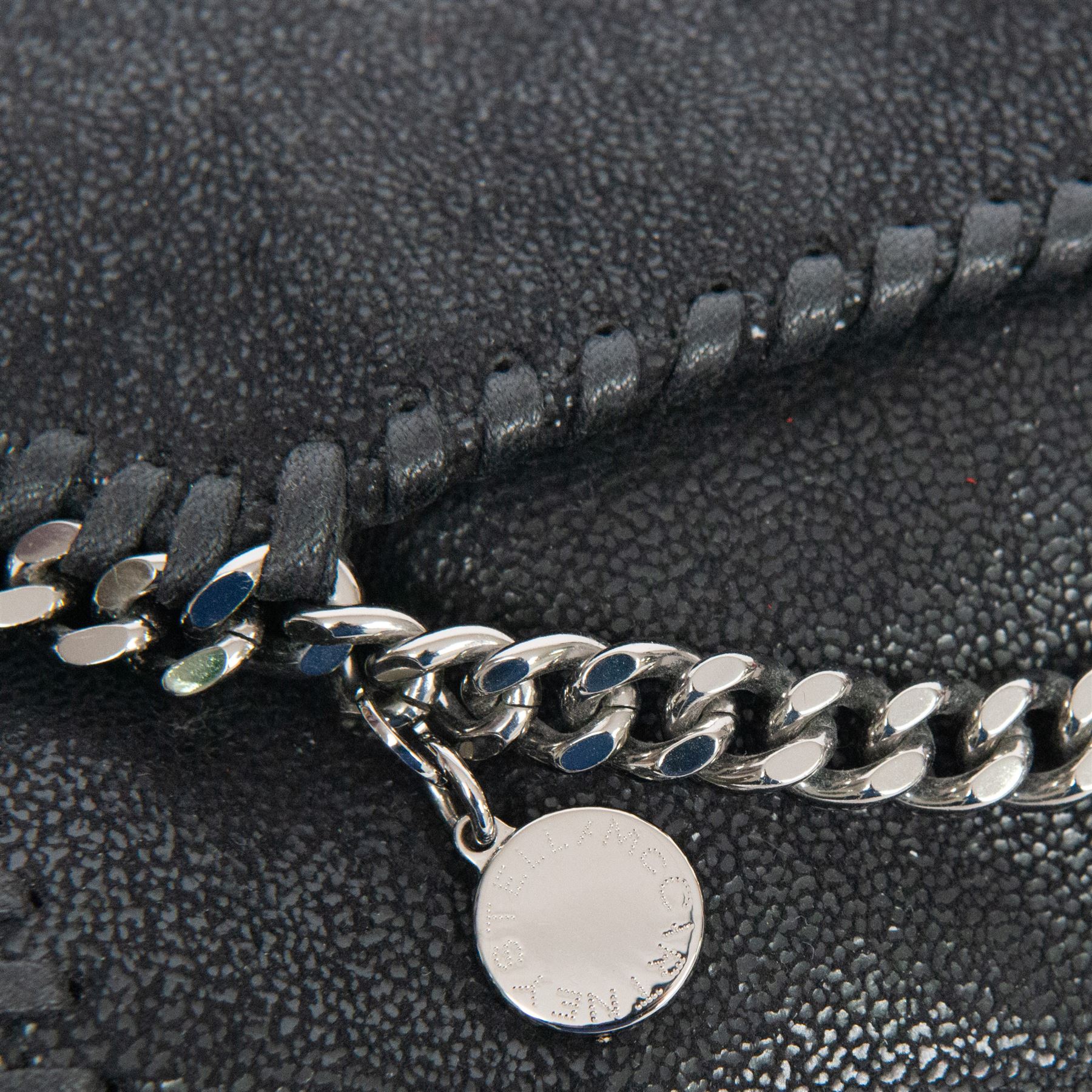 Stella McCartney Falabella black shaggy deer cross-body bag, the compact foldover design with signature silver-tone curb chain trim and chain strap, logo disc charm and pink logo lining, stamped Stella McCartney Made in Italy, with dust bag