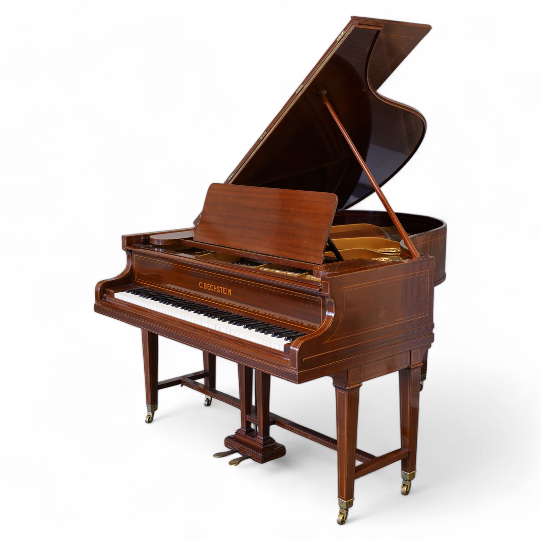 Carl Bechstein model A  grand piano serial No 44945 (1898), in a Sheraton revival mahogany case with inlaid satinwood stringing, overstrung cast iron frame raised on dual square tapering legs with brass castors, solid music desk and conforming lyre, 85 note (7 octave) A-A compass, sostenuto and sustain pedals, original action, hammers, dampers and stringing.

This item has been registered for sale under Section 10 of the APHA Ivory Act