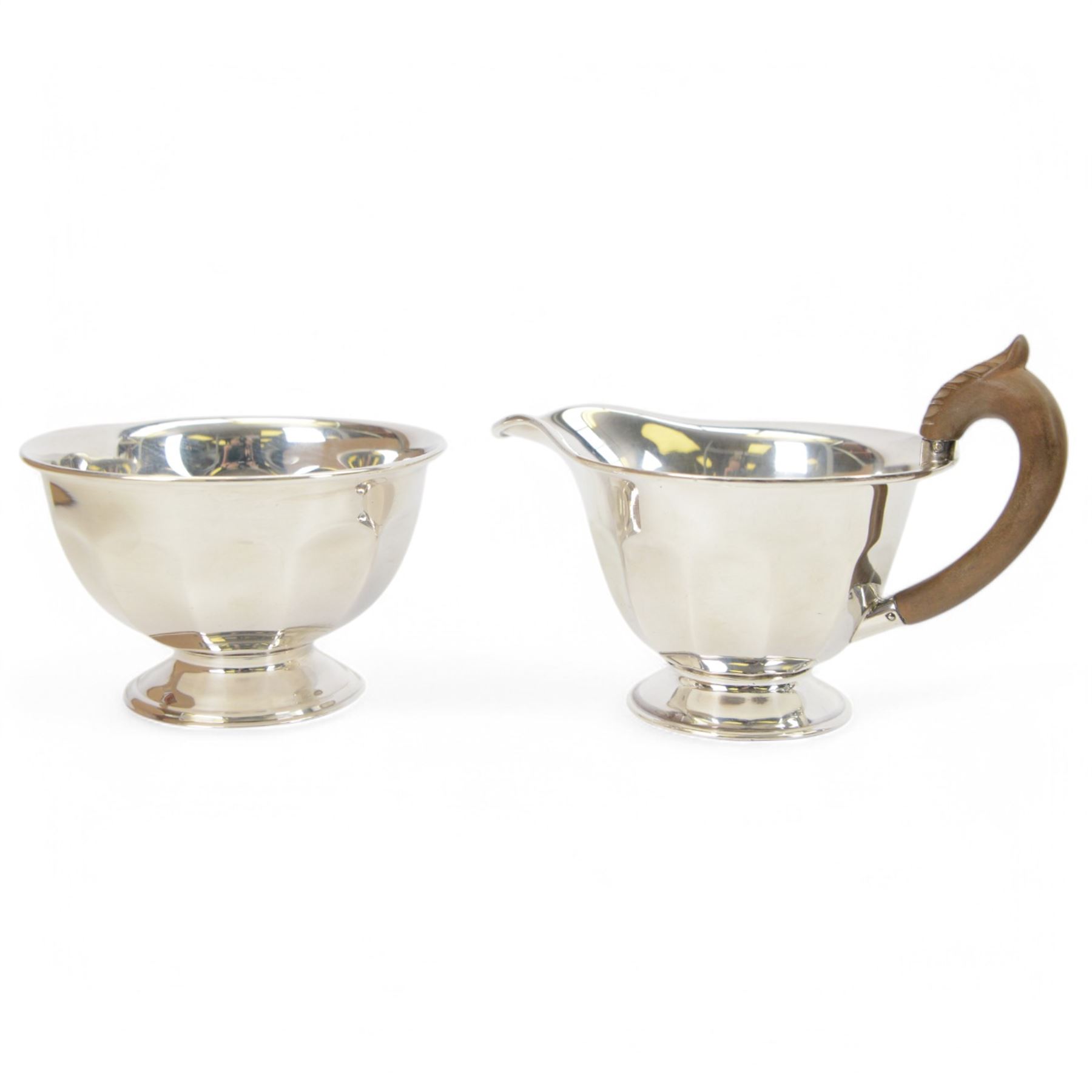 1930s silver three piece tea service, comprising teapot, open sucrier and milk jug, each of circular part fluted form, the jug and teapot with Bakelite type handles, hallmarked Viner's Ltd,  Sheffield 1935
