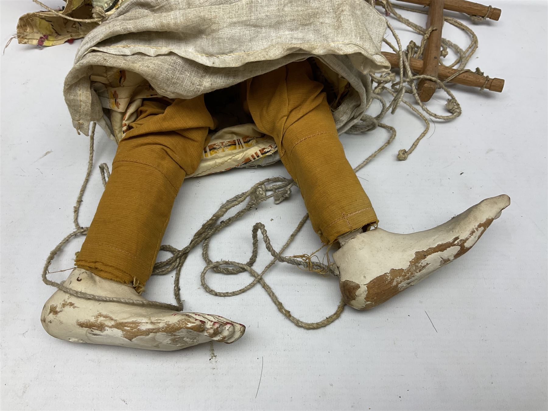 Large string puppet, probably Thai or Burmese, modelled as a woman in traditional costume embellished with sequins, the painted head with articulated mouth, the wood body and hands jointed, L70cm