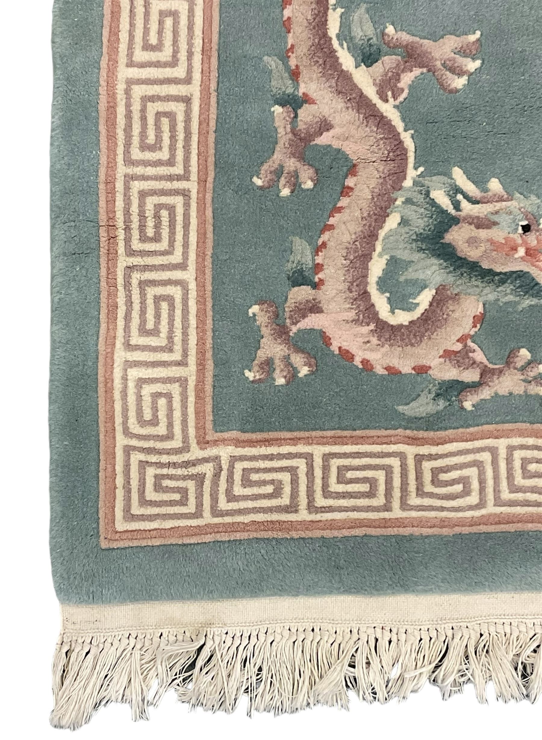 Chinese jade ground woollen rug decorated with dragons 