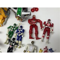 Collection of early 90s Mighty Morphin’ Power Rangers Zords, figures and accessories. Titanus the Carrier Zord, marked Bandai 1991; Green Dragonzord, incomplete; 1994 White Tigerzord with original instruction manual; 1993 Triceratops Dinozord, Mastodon Dinozord and Sabertooth Tiger Dinozord, Pterodactyl Dinozord, missing guns; with 1993 Power Morpher and original Power Coins, with further related figures, accessories and weapons