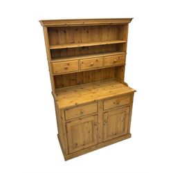 Solid pine dresser, raised plate rack with three drawers, above two drawers and two cupboards