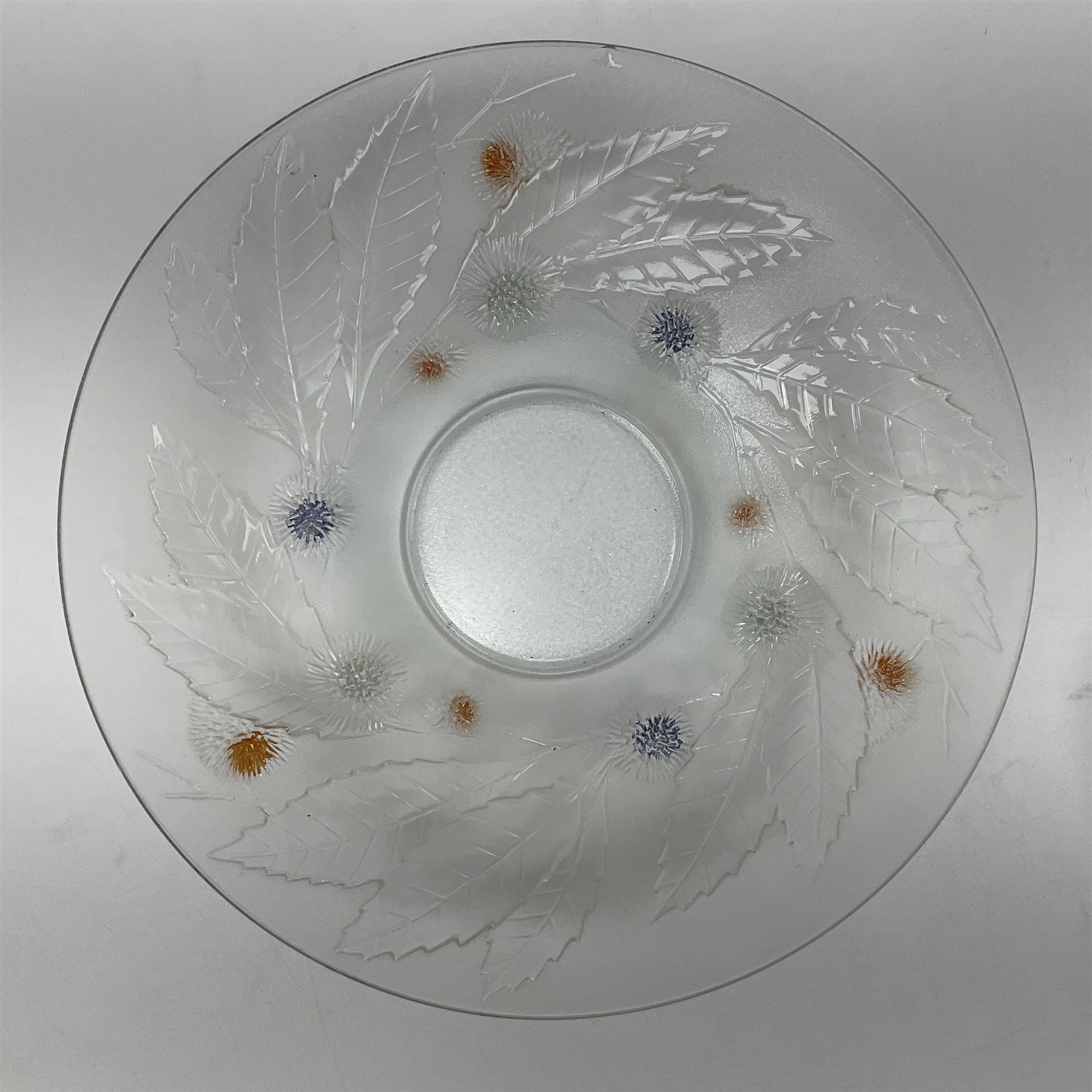 Two French pressed glass bowls of shallow circular form, relief moulded with flowers and foliage, together with a matching charger, largest bowl D34cm  