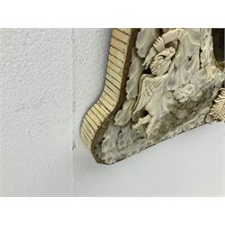 Pair 19th century French Dieppe bone and ivory wall mirrors, the oval bevelled mirror plates within rectangular frames with shaped tops, profusely decorated with ivory leaves, further detailed with carved bone armorial type crest inscribed 'SGOTORVM', putti, fish and mask heads, H81cm W48cm