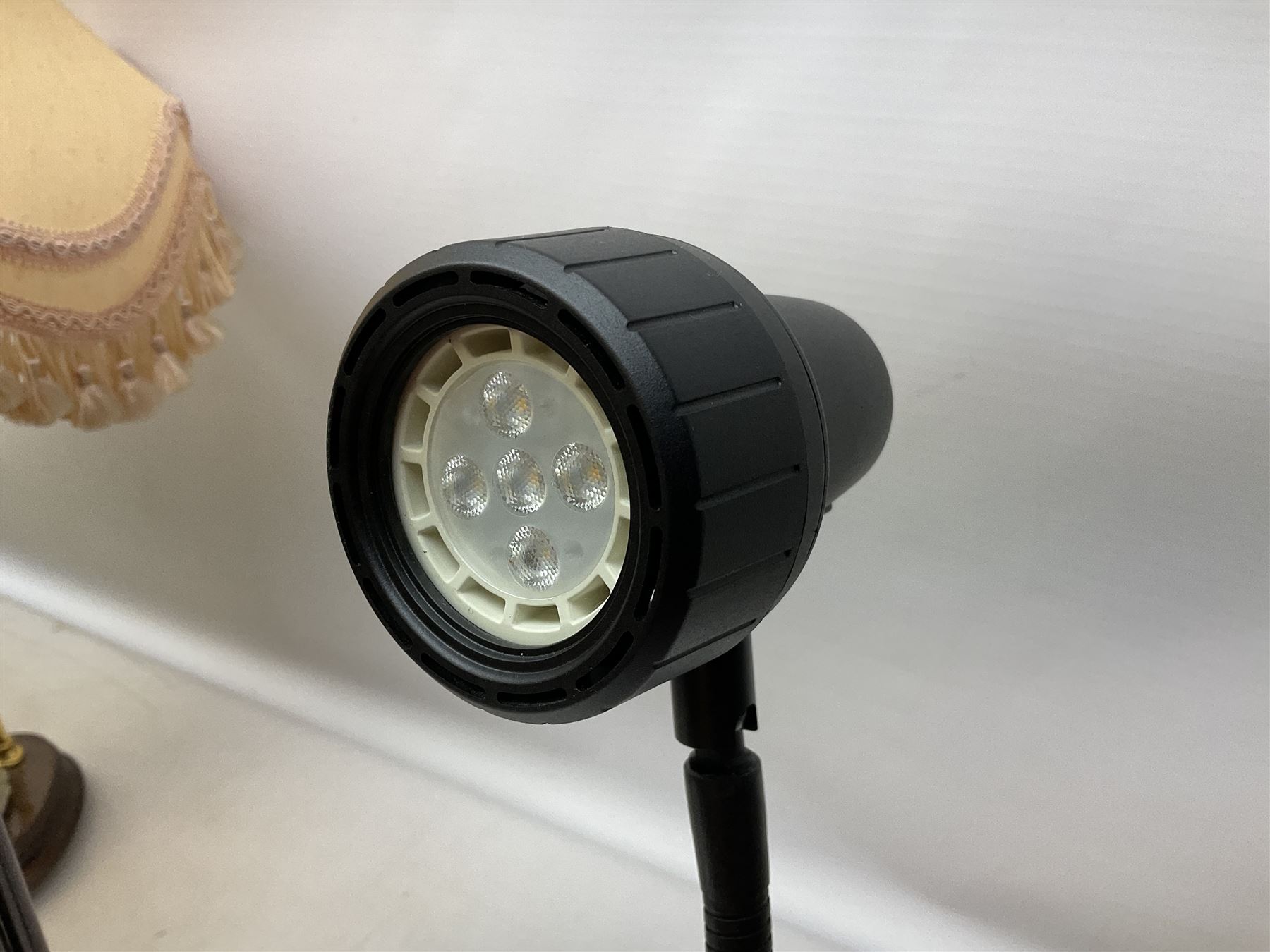 A Belcari figural table lamp, modelled as a young gent leaning upon brick wall, on turned wood base, signed, H70cm incl shade, together with bronzed figural table lamp of a lady with parasol upon ornate circular plinth base, two ceramic table lamps and another lamp (5)