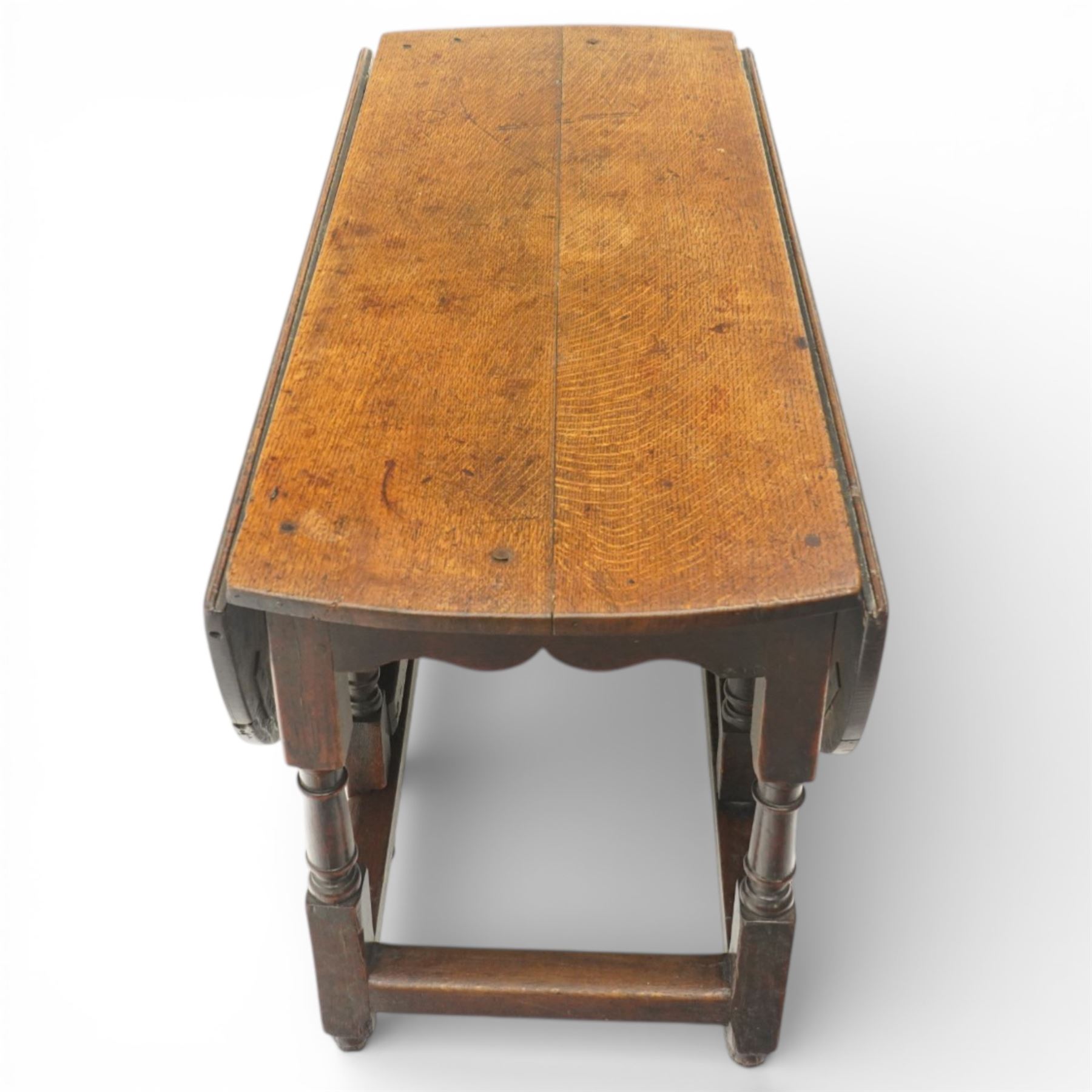 18th century large oak gateleg table, of plank top construction with visible dowels, with drop leaves to form an oval table 167cm in width, raised on block and turned supports