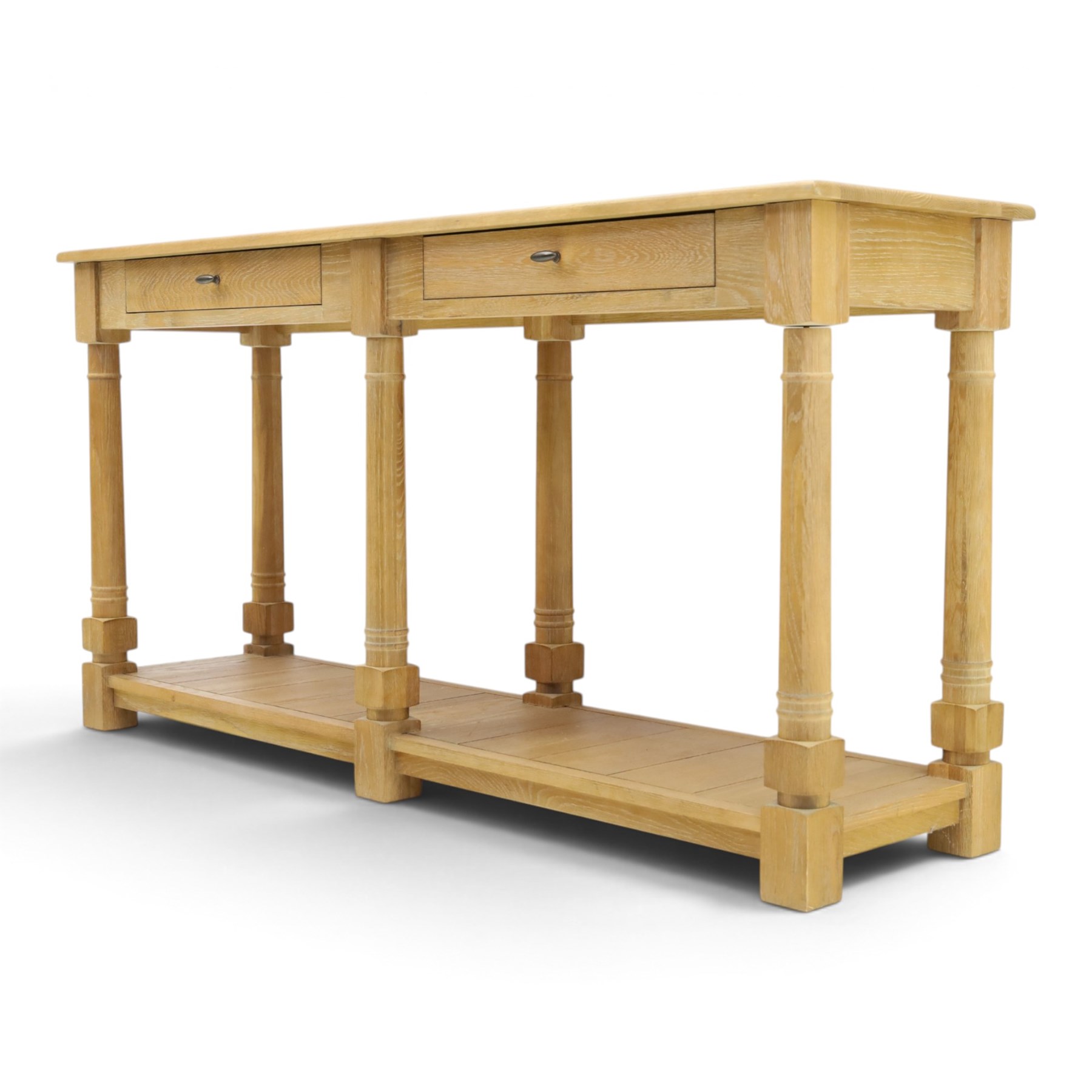 Neptune - 'Edinburgh' limed oak console table, with two
soft close drawers raised on ring-turned column supports,
with a pot shelf raised on square feet