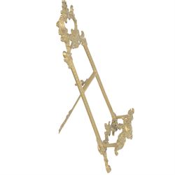 Three Baroque design brass table easels, the largest with cast mask detail, H47cm, and two matched graduated examples, smallest H25cm