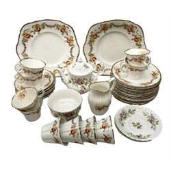 Quantity of Royal Albert tea wares to include 'Moss Rose' teapot, sucrier and saucers, together with teacups, saucers, side plates, jug etc decorated with orange, yellow and blue floral sprays with gilding upon plain ground, all stamped Royal Albert beneath