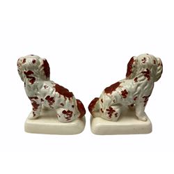Three pairs of Staffordshire style figures, comprising pair of spaniels with queen victoria's children stood next to them on a naturalistic decorated base H31cm, pair of red and white spaniels on a plinth H22cm and another pair of spaniels H28cm.   