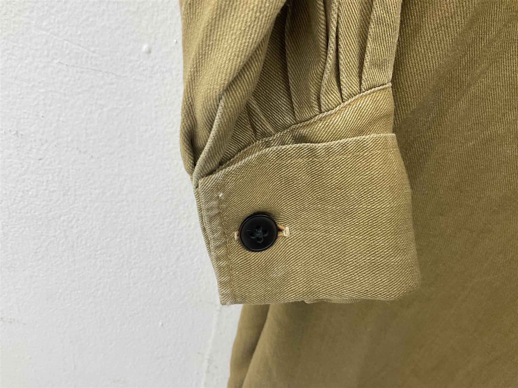 1930s Hitler Youth brown shirt, long length with two pockets, bears triangular badge 'Nord Nordsee'