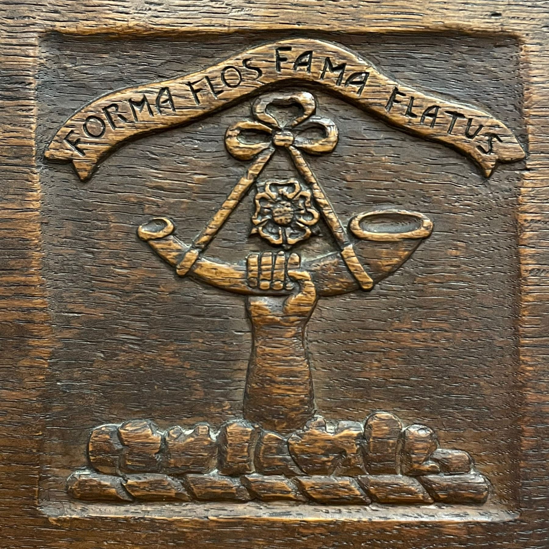 Mouseman - circa. 1930s set of six (4+2) oak dining chairs, panelled back carved with the Bagshawe family crest, the moto 'Forma Flos Fama Flatus' over an arm grasping a bugle-horn with ribbon tie and Yorkshire rose motif, adzed frame, leather lattice strap seat, on octagonal supports united by stretchers, two carvers and four side chairs, each carved with mouse signature, by Robert Thompson of Kilburn 

Provenance: Owned since manufacture by the Bagshawe family, descendants of the Staithes Group Artist Joseph Richard Bagshawe RBA (1870-1909).