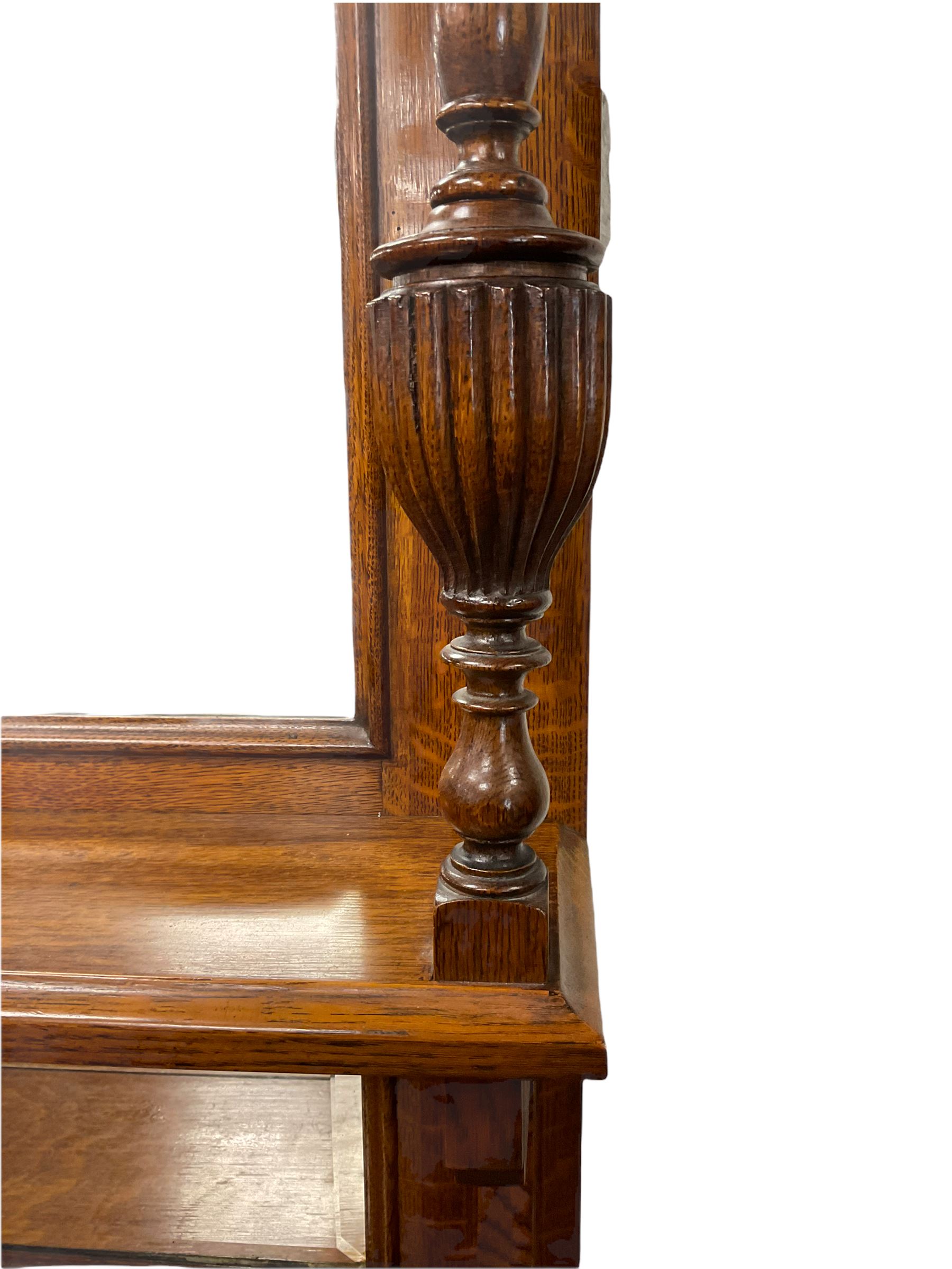 Edwardian oak mirror back sideboard, raised shaped pediment carved with acanthus leaves over Greek key frieze, bevelled mirror back, fitted with two drawers and two cupboards