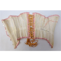  Early 20th century French pink silk corset/ stay, whalebone supports, lace edging and embroidered floral sprigs, metal grommets/ eyelets  