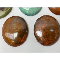 Henry George Murphy (1884-1939), collection of seven Arts & Crafts glazed ceramic roundels, of circular and oval form, five in tones of red and brown and two in tones of blue, turquoise and green in soufflé and high fired finishes, largest example D6.5cm