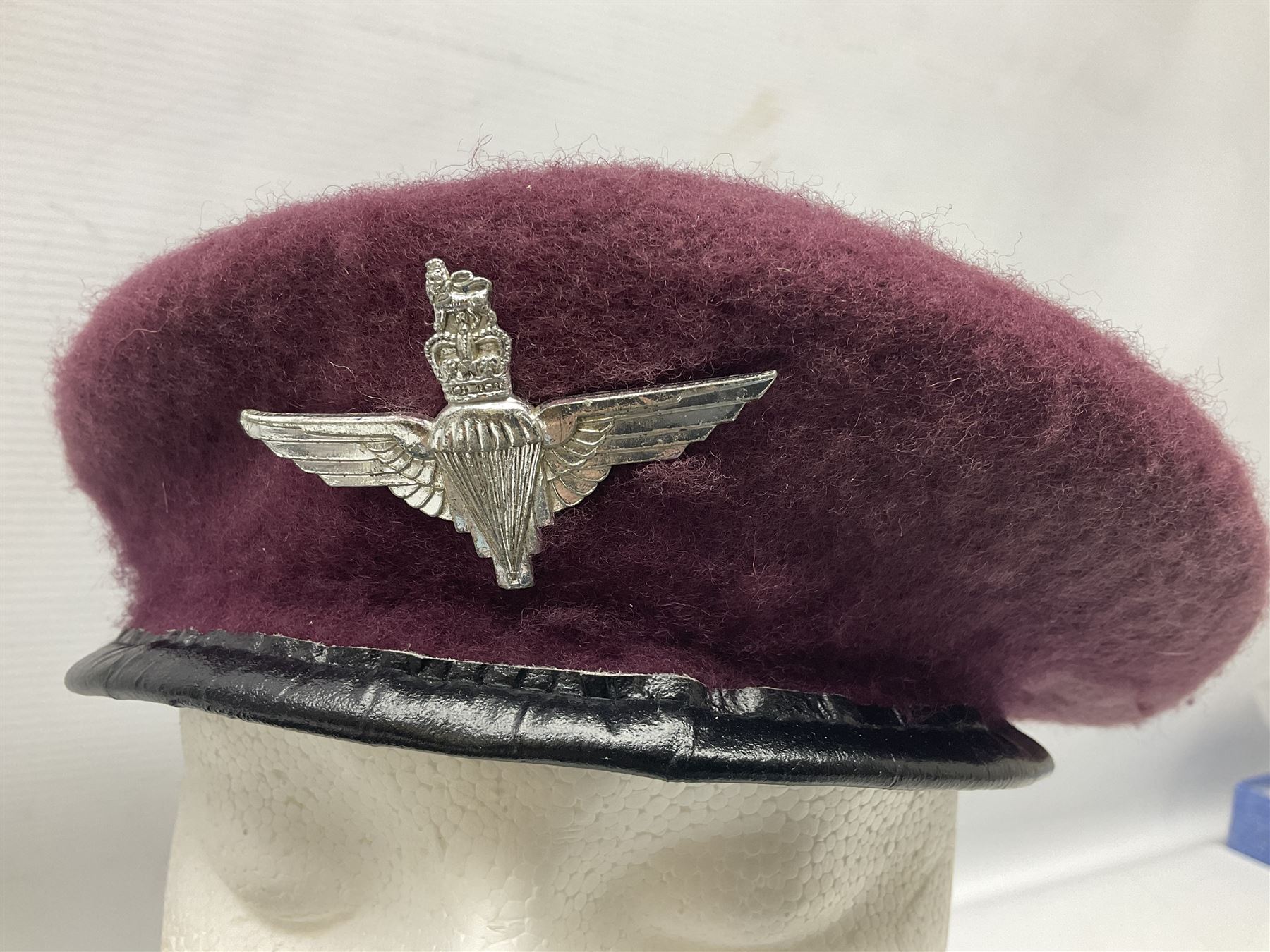 Four paratrooper berets - Russian, Italian, British and Foreign Legion; all with badges (4)