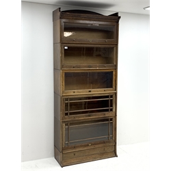 Early 20th century oak stacking library bookcase, five graduating sections with hinged and sliding glazed doors, single drawer to base, W89cm, H219cm, D35cm