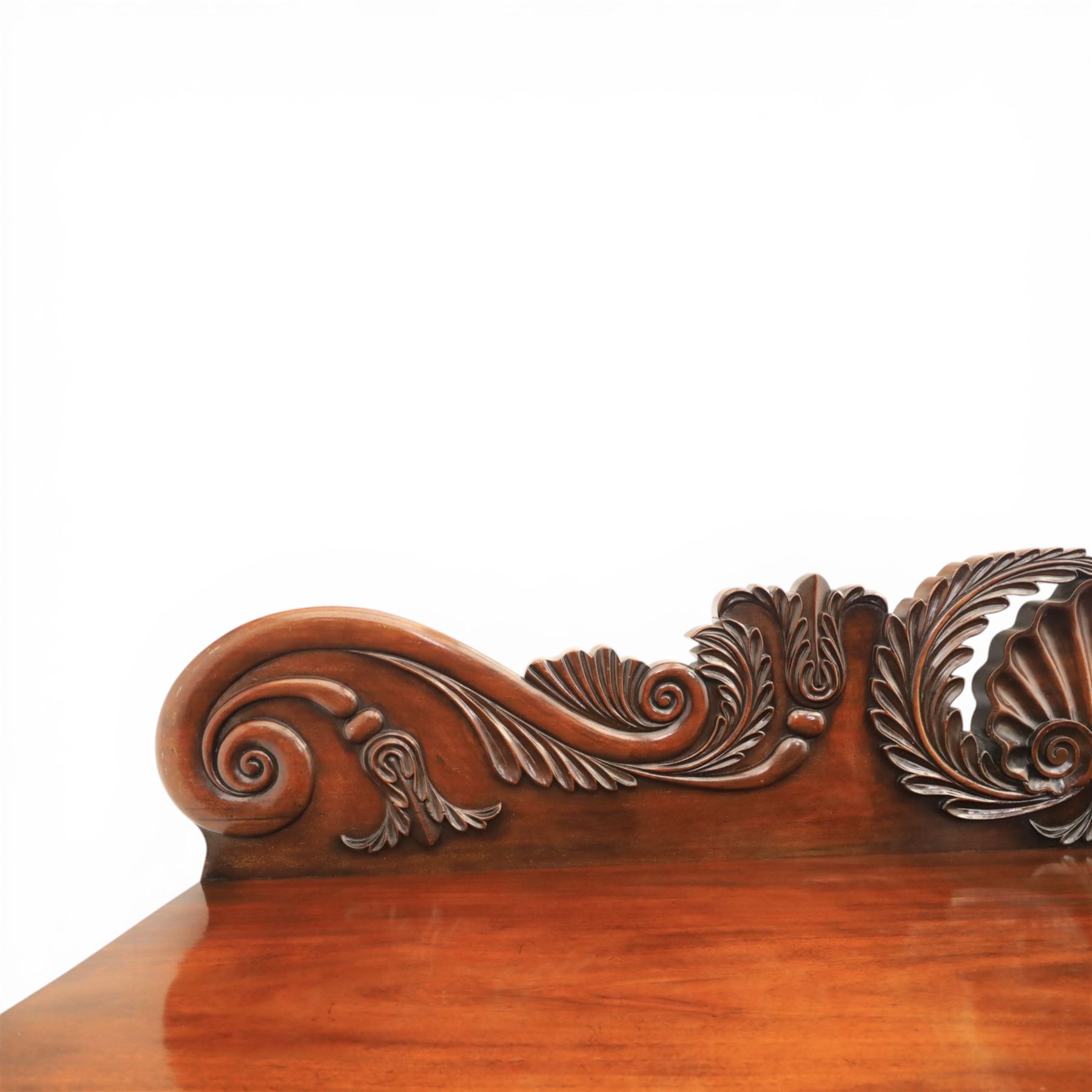 Mid Victorian mahogany pedestal sideboard, the rectangular top with raised back centred by a carved shell within scrolling acanthus and foliate cresting, over a central shaped frieze drawer flanked by two short drawers, above a kneehole recess, flanked by panelled cupboard doors with carved corbel supports, enclosing shelved interiors
