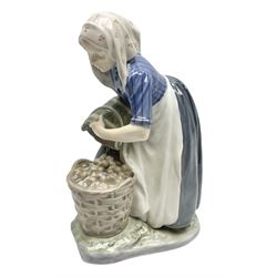 Royal Copenhagen figure, Woman Collecting Potatoes, modelled by Christian Thomsen, no 1549, with impressed and printed marks beneath, H27cm