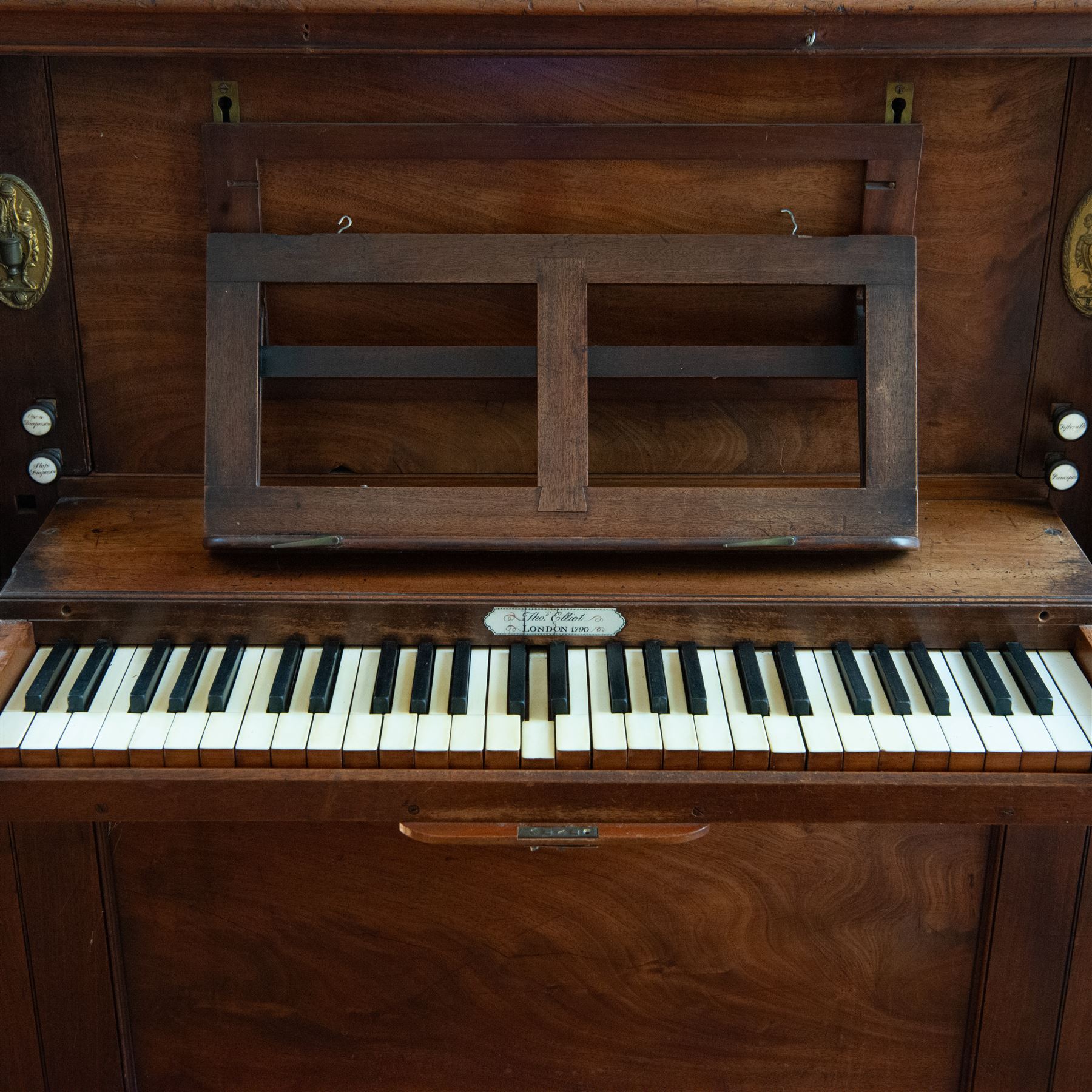 Late 18th century Chamber Organ by Thomas Elliot of London 1790.
Single manual organ, four octave keyboard with 54 keys C-f3, A=448, with Ivory naturals and ebonized sharps, makers’ name engraved on an ivory cartouche, detachable key cover, and music desk (in need of attention). With four speaking stops. Stopped Diapason, Open diapason, Principal and Fifteenth. Crank/pedal operated single rise bellows also provided with an electric blower. Original case with display pipes and candle sconces (one damaged). All pipework present: however there are some damaged pipes, cyphers, and several pipes require re-location in the soundboard, the instrument plays, but some parts of the action and blower will require attention/repair and adjustment.

Given the intricate nature of these historic instruments, specialist support will be available if required – including a professional organ builder prepared to undertake full dismantling and reassembly – to assist successful buyers with safe removal and onward handling. Price upon application.


This item has been registered for sale under section 10 of the APHA Ivory Act Reference EH8B3YPL