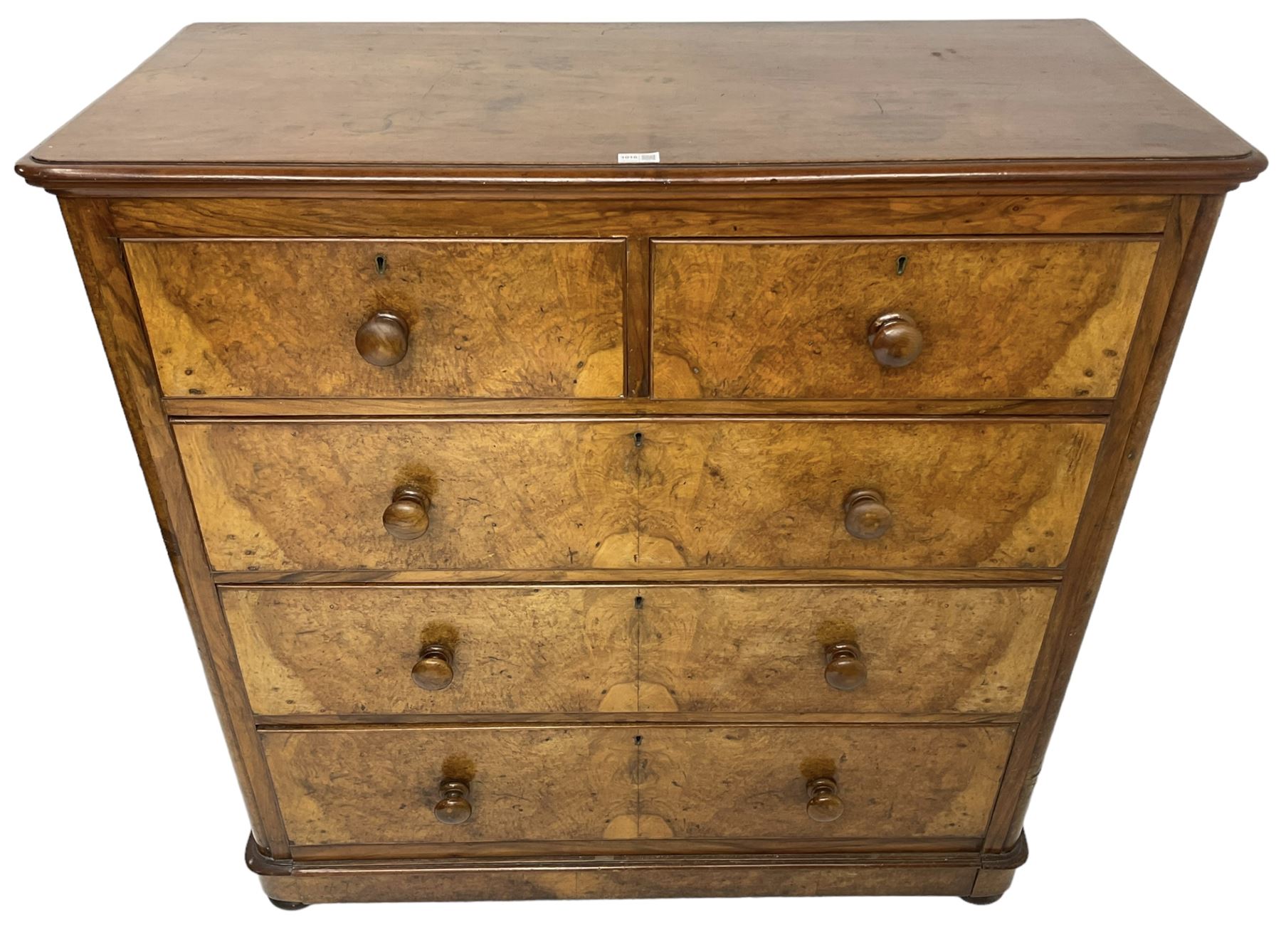 Early 20th century figured walnut chest, fitted with two short over three long drawers with bookmatch veneer facias, each with turned walnut handles, skirted base over compressed bun feet 