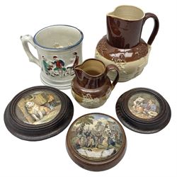 Three Prattware pot lids mounted in wood frames, Staffordshire frog mug, Doulton Lambeth jug etc, largest H18cm