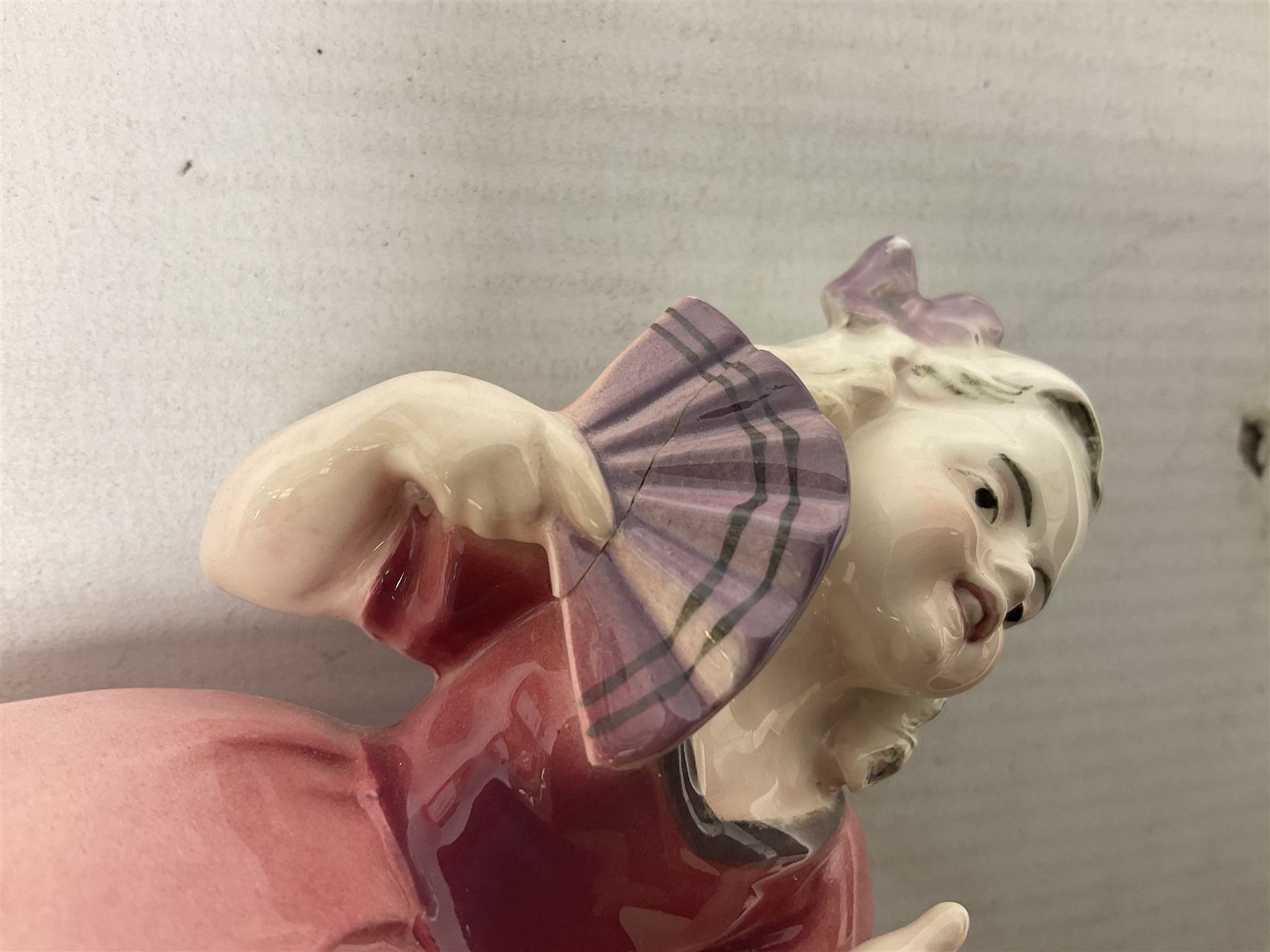 Early 20th century Katzhütte figure of a pointer dog, and figure of a young girl holding basket and fan, both with green cat H house printed mark beneath, dog L25cm