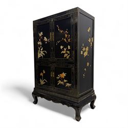 Late 20th century Chinoiserie black lacquer cabinet, the rectangular body decorated with hand-painted floral and foliate motifs in polychrome and gilt, fitted with four panel doors enclosing shelved interior, on shaped apron and stylised cabriole supports with gilt scrollwork