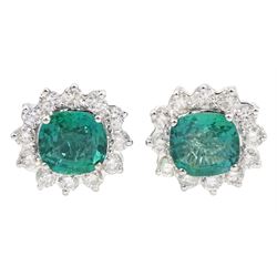 Pair of 18ct white gold, cushion cut emerald and round brilliant cut diamond cluster stud earrings, stamped 18K, total emerald weight approx 2.70 carat, total diamond weight approx 1.10 carat