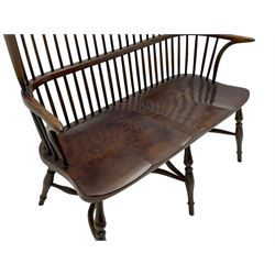 Traditional elm and oak two seat Windsor bench, high comb and stick back, double dished seat on turned supports joined by two crinoline stretchers