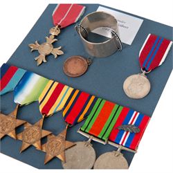 WWII Medal group awarded to Commander John Cecil Gilbert Martin, Royal Navy; OBE, 1939-1945 Star, Atlantic Star, Africa Star, Burma Star, War Medal, Defence Medal, Queen Elizabeth II Coronation medal and Royal Life Saving Society Medal, together with engraved silver napkin ring, hallmarked, engraved silver plated tin, OBE documentation and other ephemera relating to Commander John Cecil Gilbert Martin